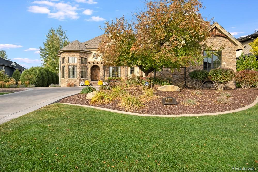 6570 Rookery Road Fort Collins, CO 80528 - Photo 1 of 40 a view of a house with a big yard potted plants and large tree