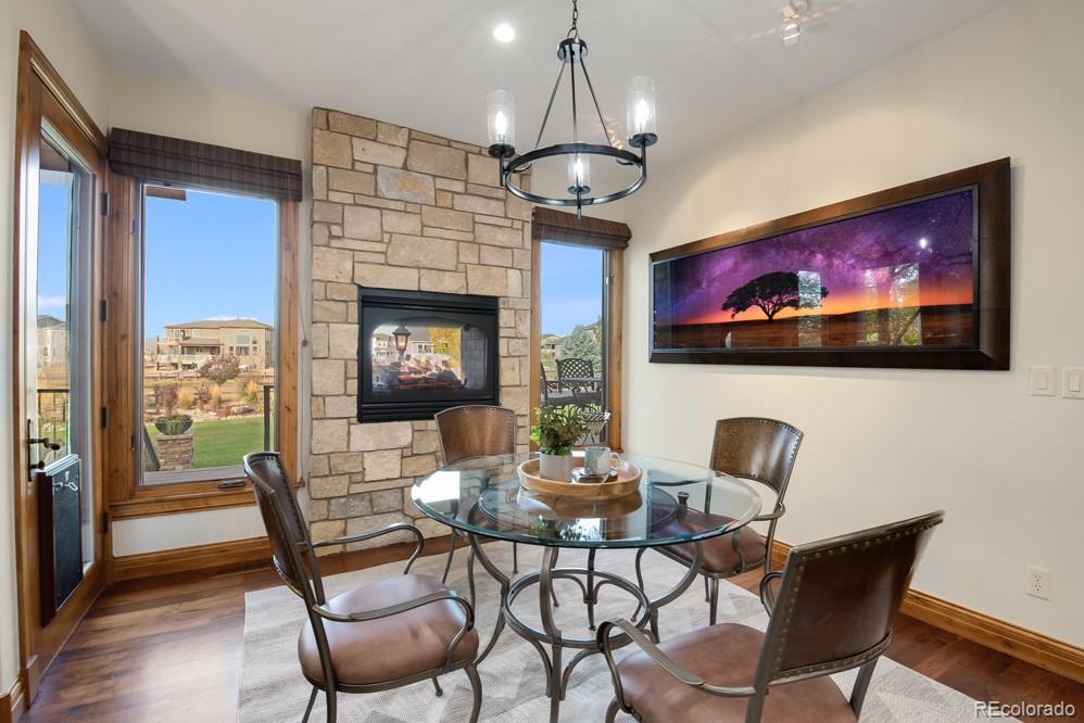 6570 Rookery Road Fort Collins, CO 80528 - Photo 13 of 40 a dining room with furniture a chandelier and wooden floor