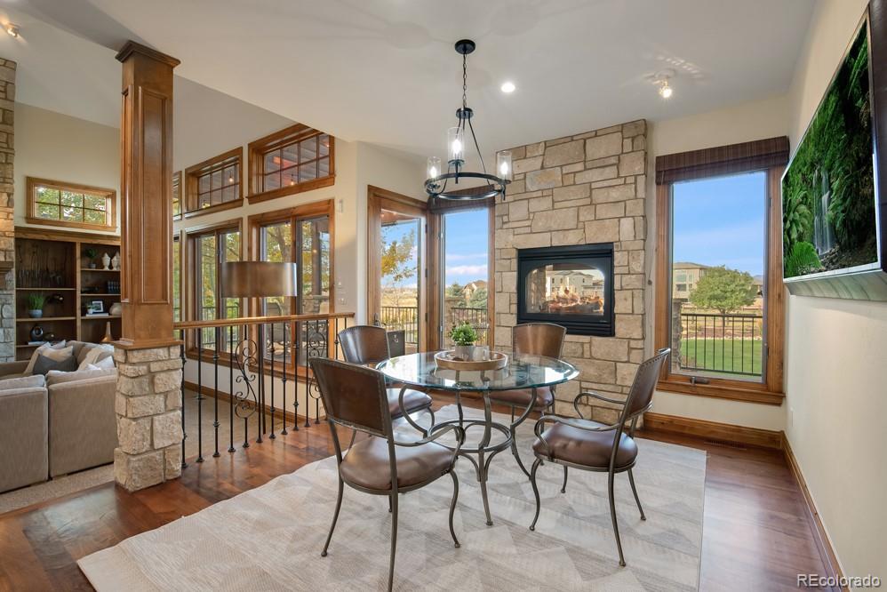 6570 Rookery Road Fort Collins, CO 80528 - Photo 14 of 40 a dining room with furniture a chandelier and wooden floor