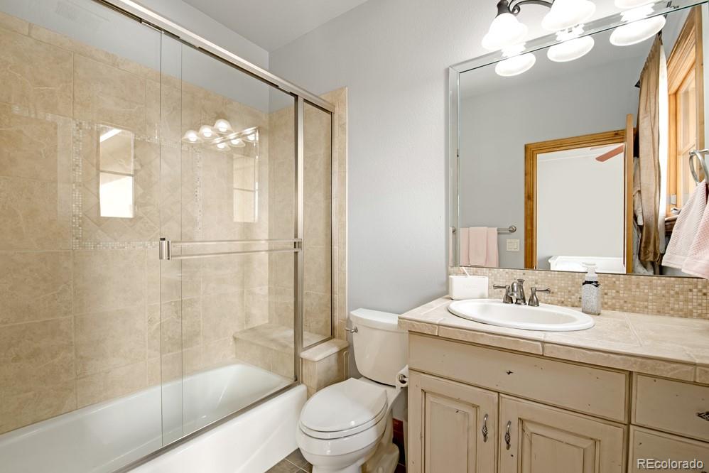 6570 Rookery Road Fort Collins, CO 80528 - Photo 24 of 40 a bathroom with a sink a toilet and shower