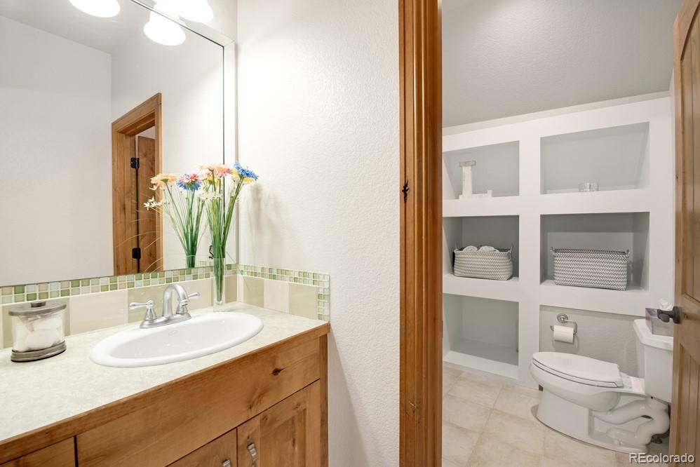 6570 Rookery Road Fort Collins, CO 80528 - Photo 26 of 40 a bathroom with a granite countertop sink and a mirror