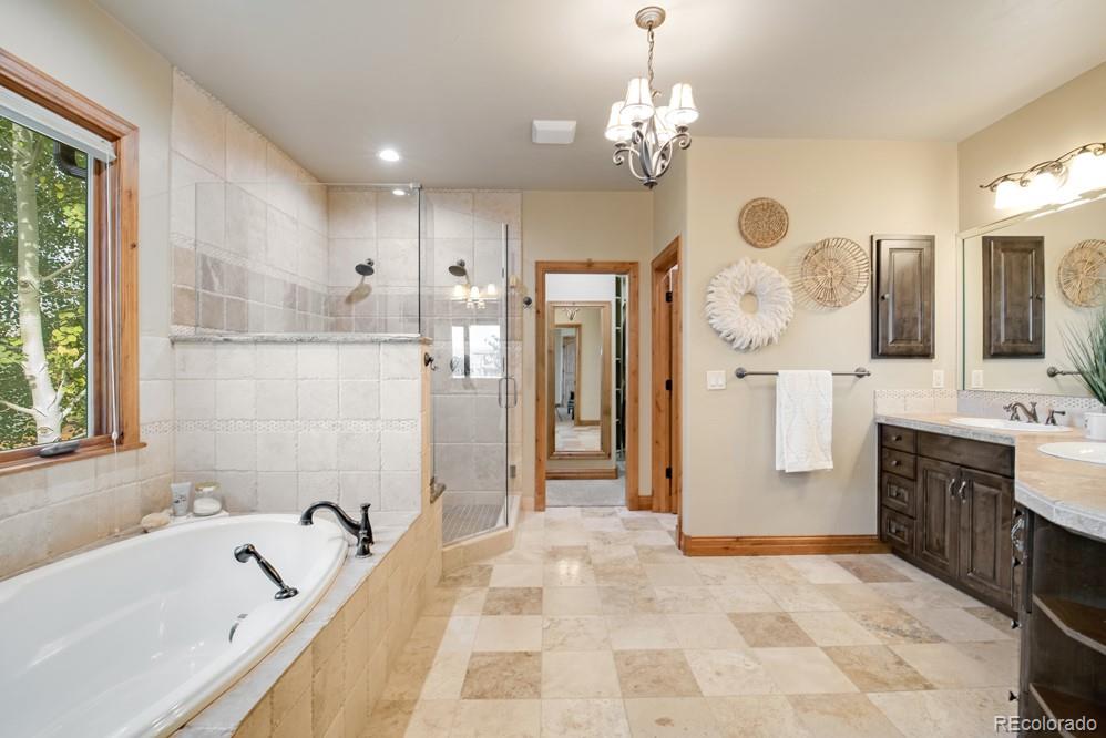 6570 Rookery Road Fort Collins, CO 80528 - Photo 30 of 40 a bathroom with a tub sink and mirror