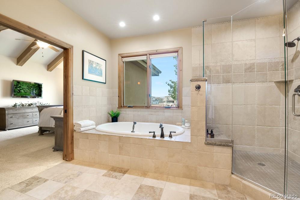 6570 Rookery Road Fort Collins, CO 80528 - Photo 31 of 40 a spacious bathroom with a tub sink and mirror
