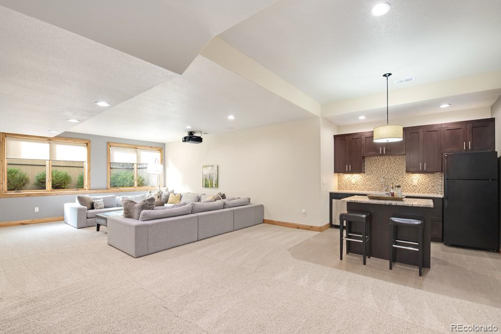 6570 Rookery Road Fort Collins, CO 80528 - Photo 32 of 40 a living room with furniture a dining table and chairs