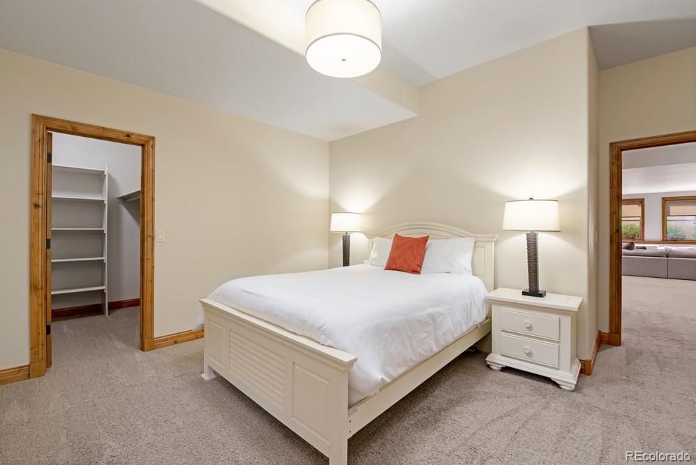 6570 Rookery Road Fort Collins, CO 80528 - Photo 36 of 40 a bedroom with a bed and a lamp
