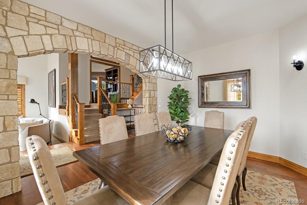 6570 Rookery Road Fort Collins, CO 80528 - Photo 6 of 40 a view of dining room and livingroom with furniture wooden floor a chandelier