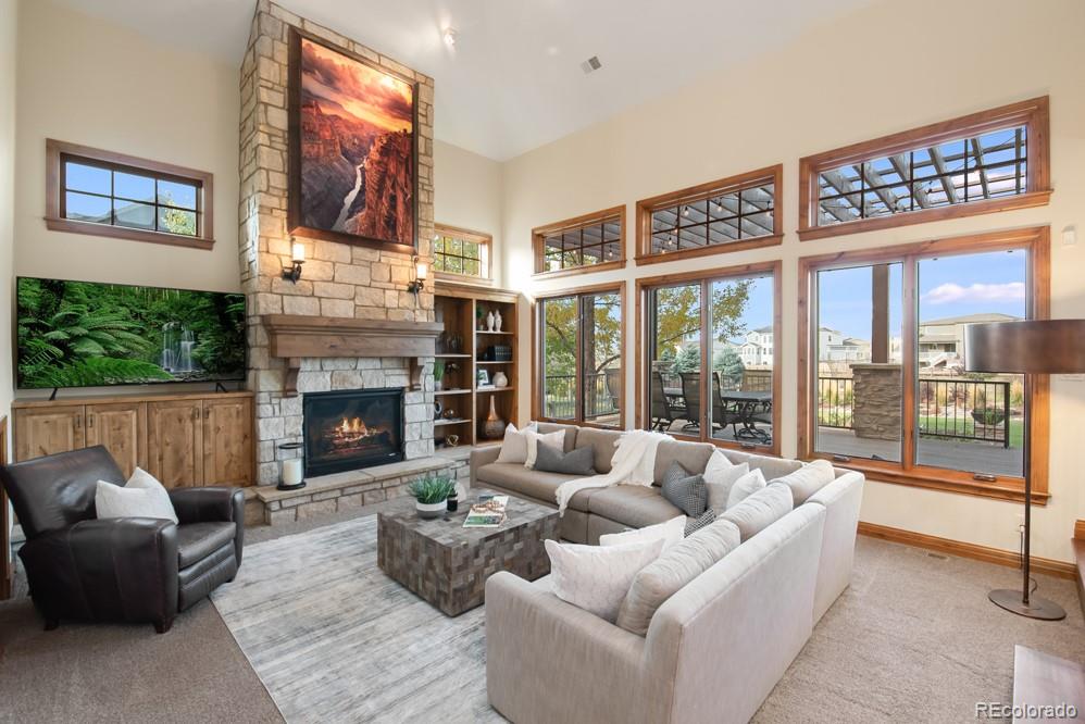 6570 Rookery Road Fort Collins, CO 80528 - Photo 10 of 40 a living room with furniture large windows and a fireplace