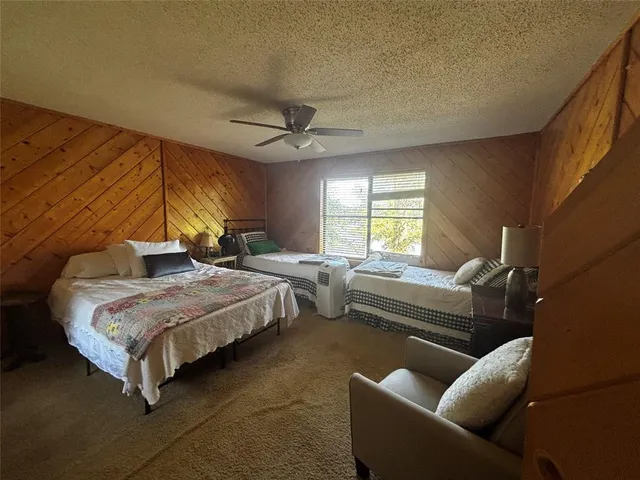 a bedroom with furniture and a large window