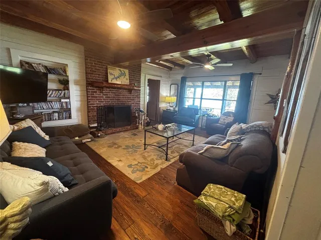 a living room with furniture fireplace and a flat screen tv