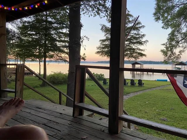 a view of a yard with wooden fence