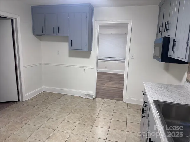 a kitchen with granite countertop a stove and a refrigerator