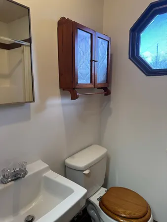 a white toilet sitting next to a bathroom sink
