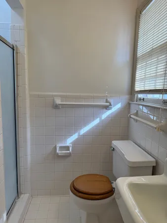 a bathroom with a toilet and a shower