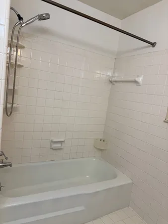 a bathroom with a shower and a bath tub