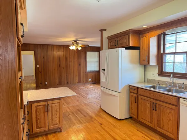 a kitchen with a refrigerator sink and cabinets