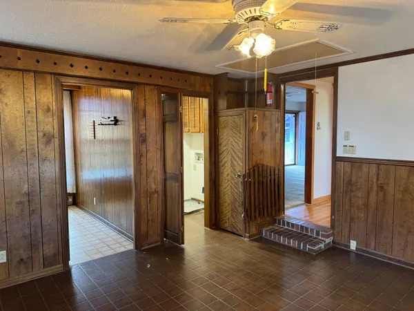 a view of a hallway with wooden floor and entryway