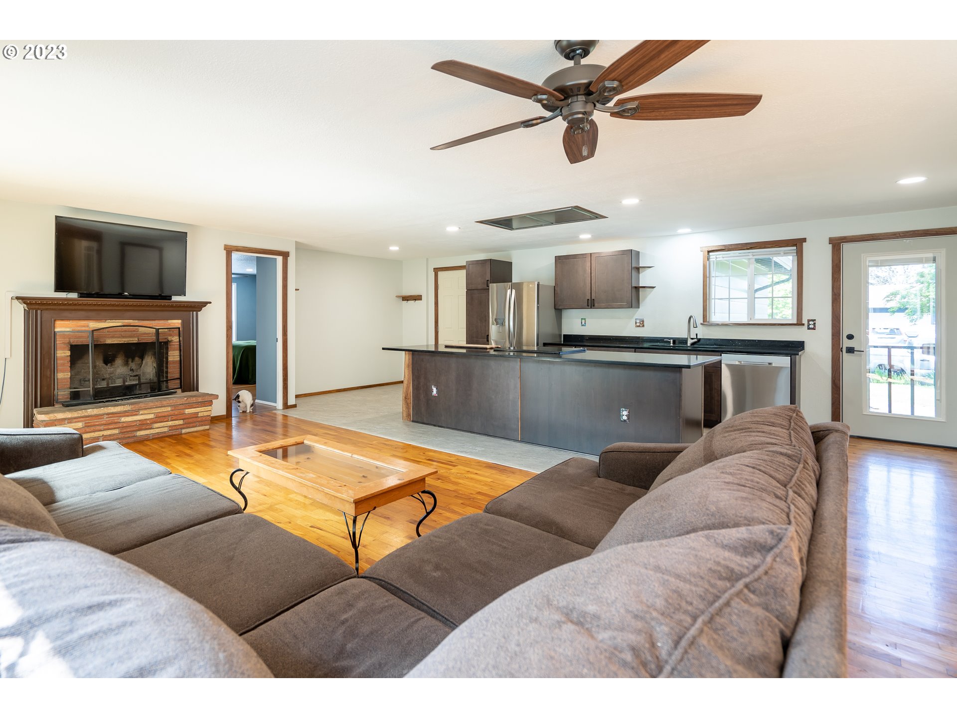 1670 Linden Avenue Springfield, OR 97477 - Photo 2 of 28 a living room with furniture a flat screen tv and kitchen view