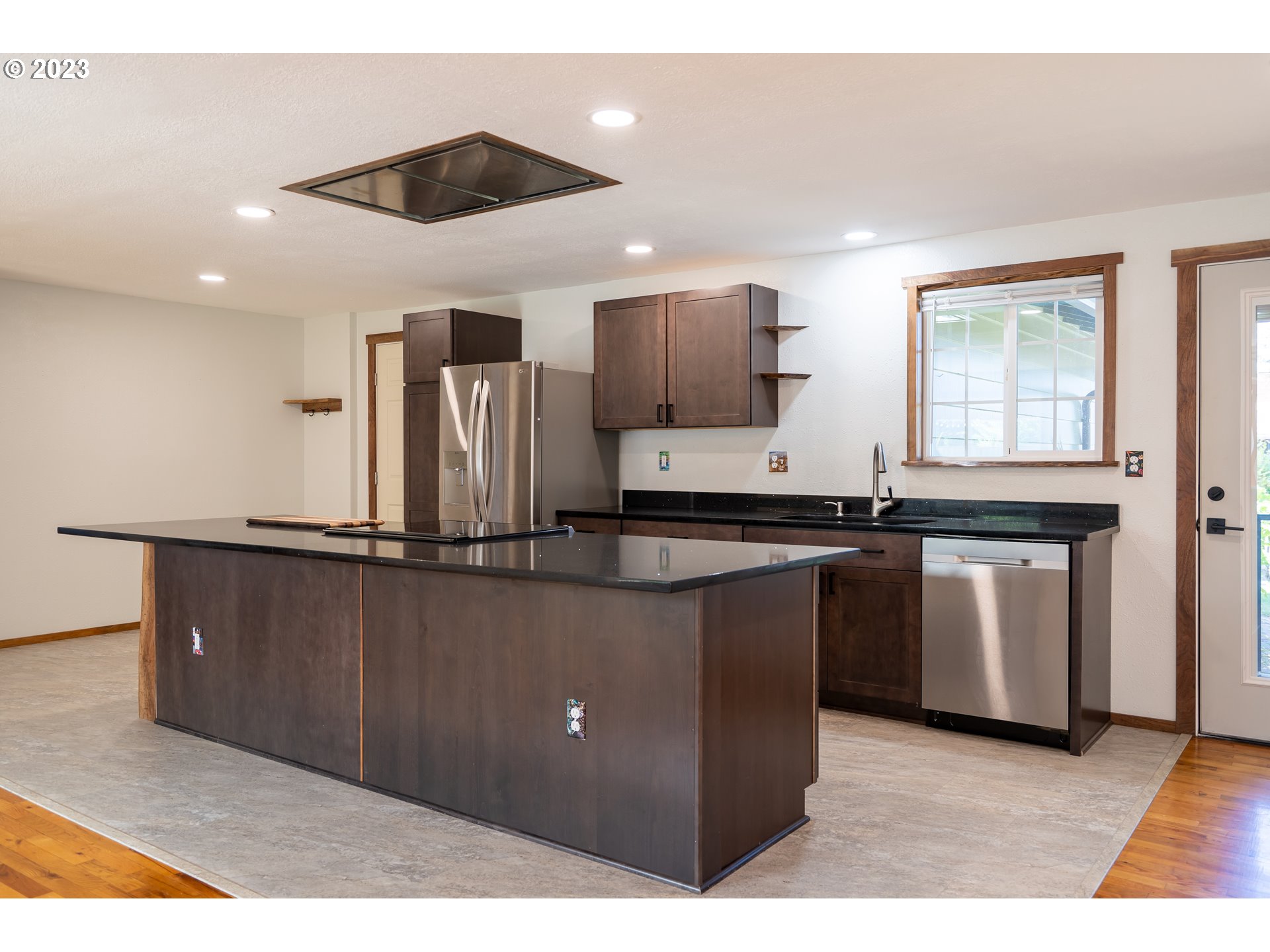 1670 Linden Avenue Springfield, OR 97477 - Photo 3 of 28 a kitchen with stainless steel appliances kitchen island granite countertop a stove a sink and a refrigerator