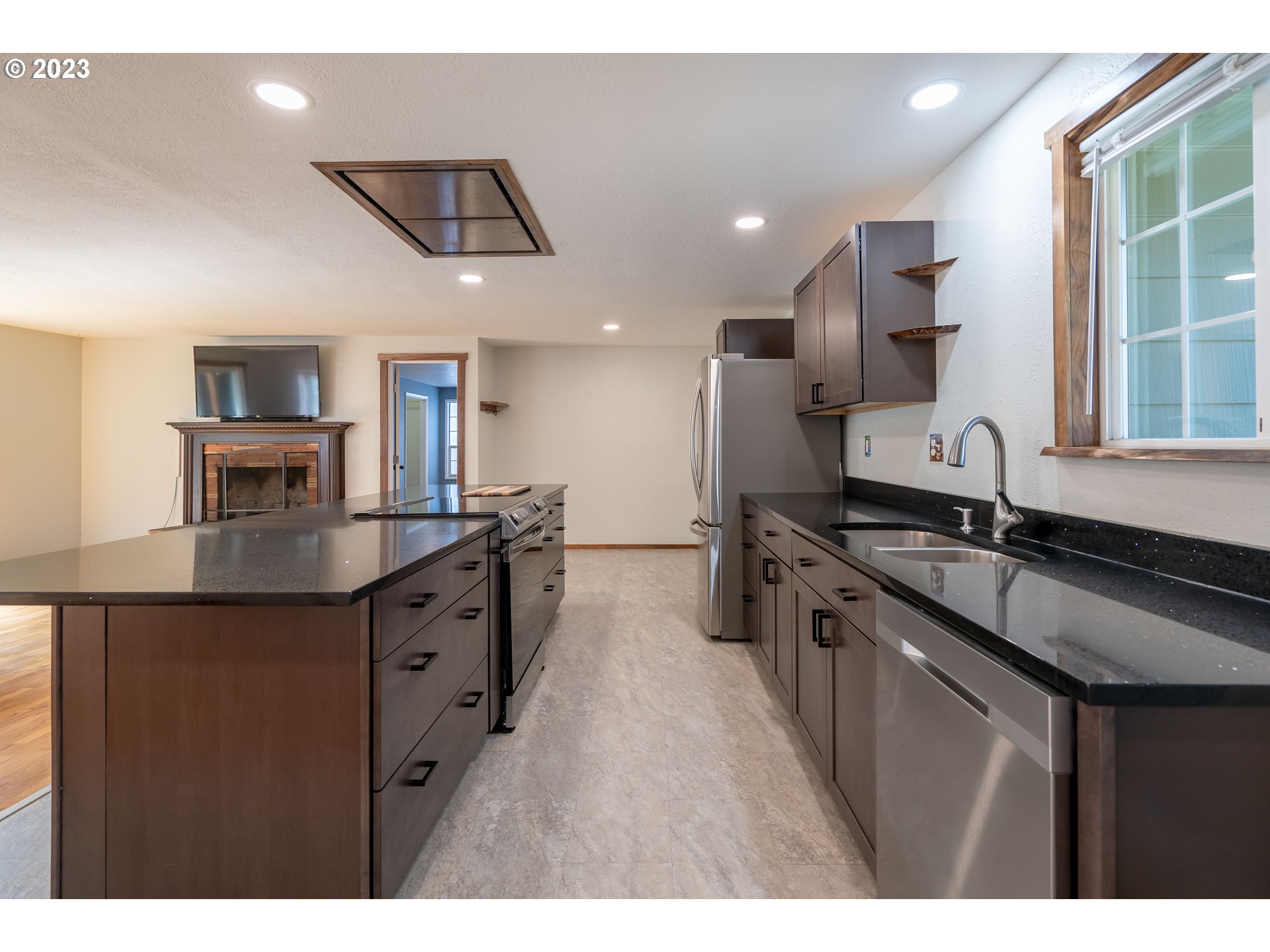 1670 Linden Avenue Springfield, OR 97477 - Photo 8 of 28 a kitchen with stainless steel appliances granite countertop a sink a stove and a refrigerator