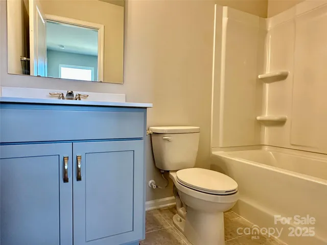 a view of a hallway with wooden floor and entryway