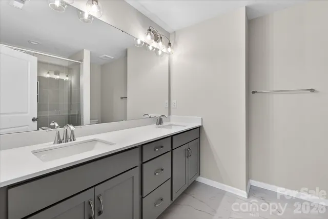 a bathroom with a double vanity sink a and a mirror