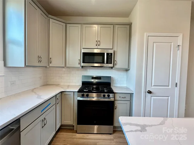 a kitchen with a stove and a microwave