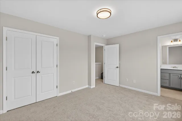 a view of a kitchen and a sink a refrigerator and cabinets