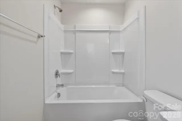 a bathroom with a bathtub and toilet