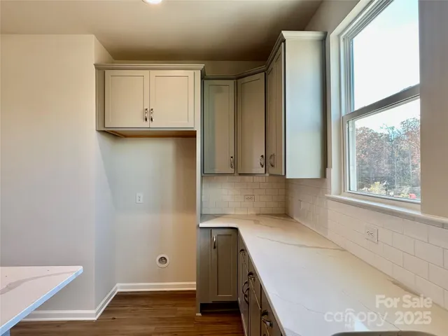 a view of kitchen with wooden floor and electronic appliances