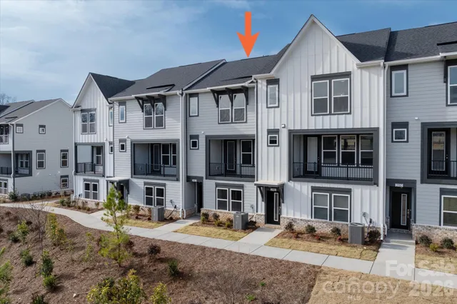 a front view of a residential apartment building with a yard