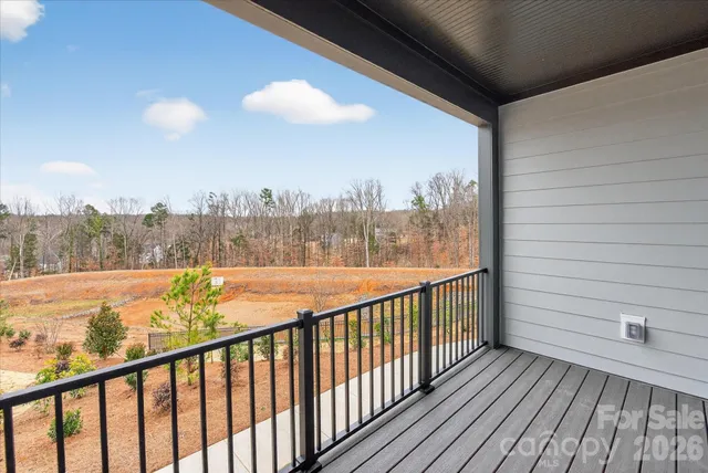 a view of a balcony with wooden floor