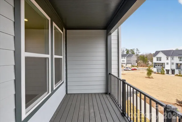 a view of a balcony with wooden floor