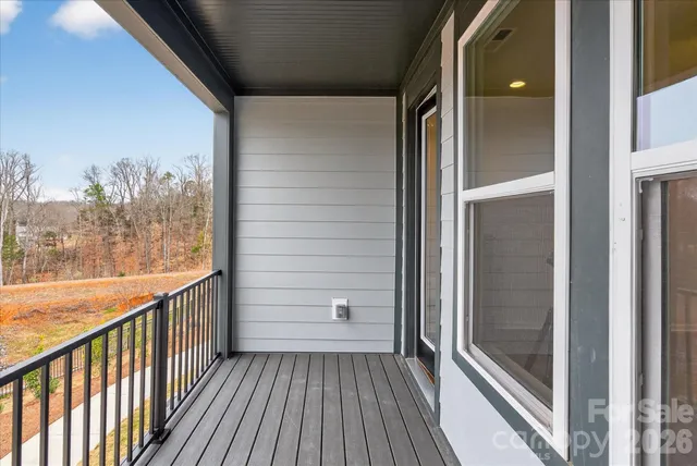 a view of a balcony with wooden floor
