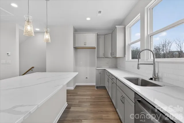 a kitchen that has a sink and a stove in it