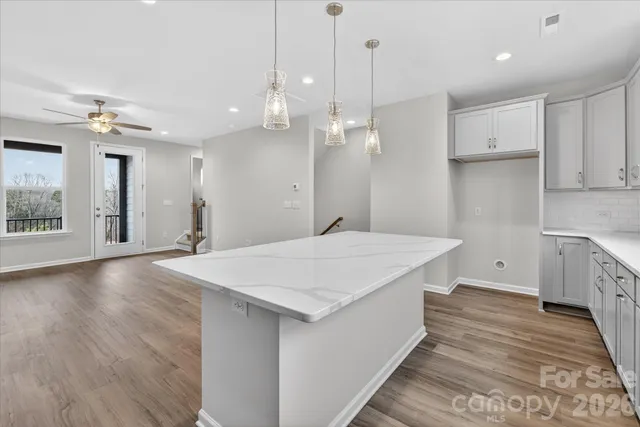 a large white kitchen with a refrigerator a sink and a stove
