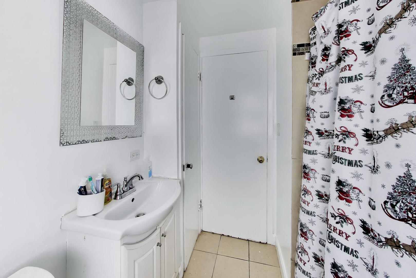 458 West Alma Street Elmhurst, IL 60126 - Photo 14 of 29 a bathroom with a sink and a mirror