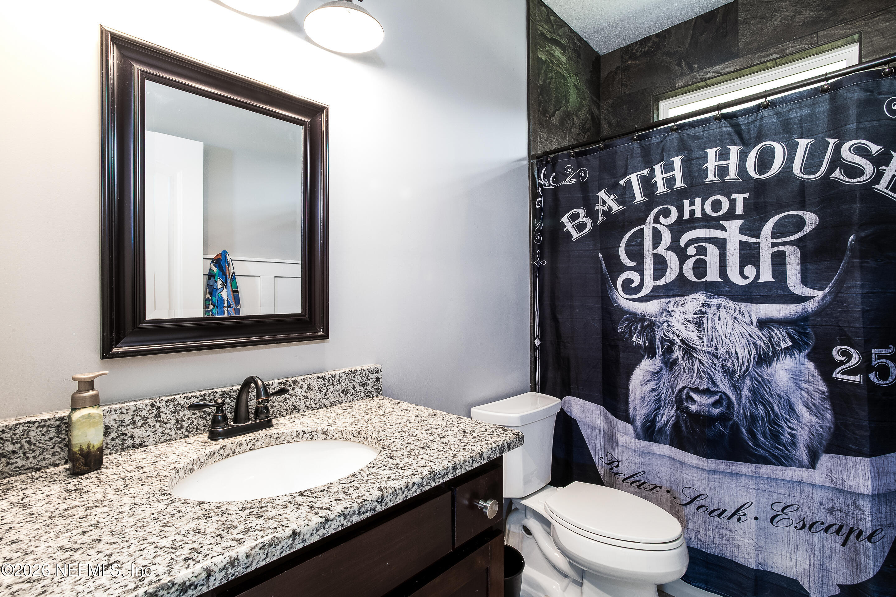 26575 Sheared Stokes Road Hilliard, FL 32046 - Photo 11 of 39 a bathroom with a granite countertop sink and a mirror
