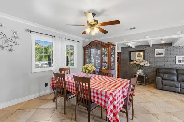 a view of a dining room with furniture and a chandelier
