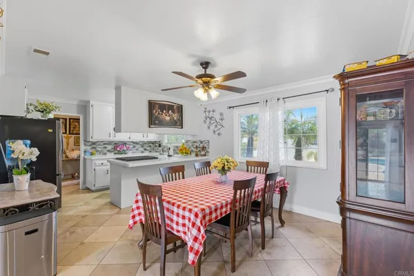 a dining room with furniture and window