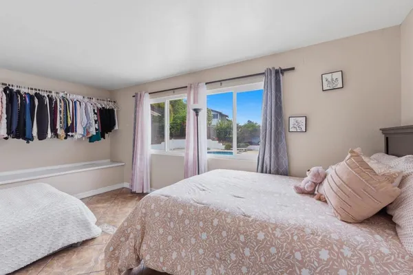 a bedroom with a bed and a large window