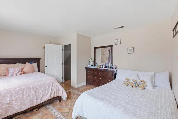 a bedroom with a bed and a dresser