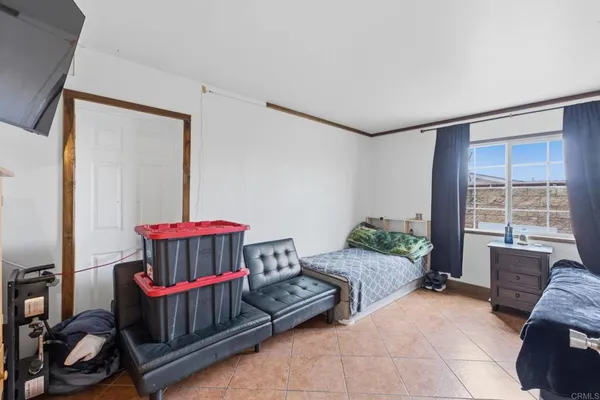 a bedroom with furniture and a window
