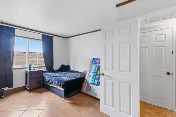 a bedroom with a bed and a window