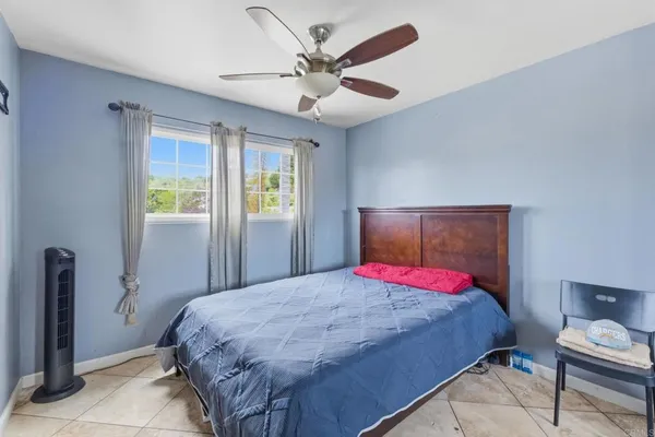 a bedroom with a bed and a ceiling fan