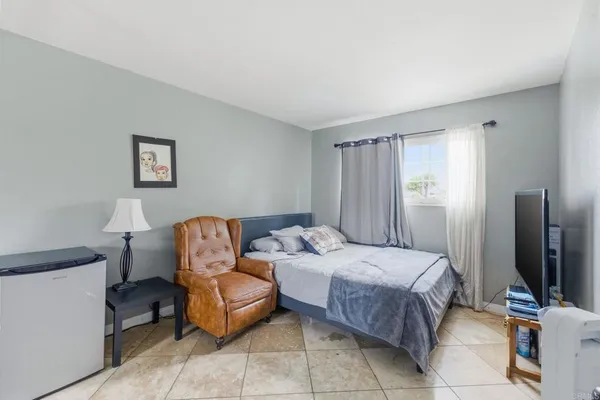 a bedroom with a bed and a couch