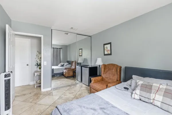 a bedroom with furniture and a lamp