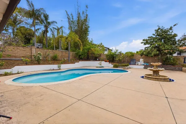 a view of a swimming pool with a yard