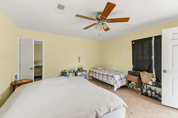 a bedroom with a bed and a dresser