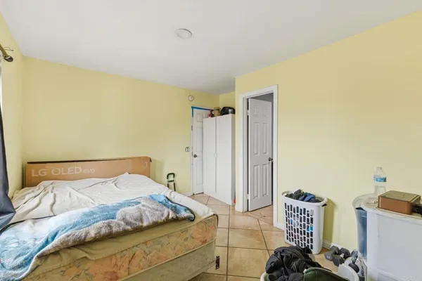 a bedroom with a bed and a dresser