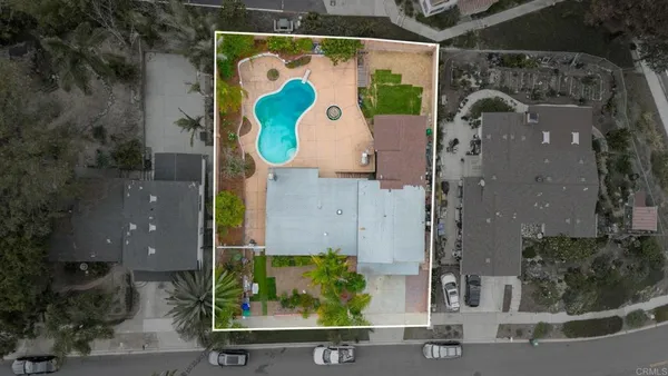 an aerial view of residential house with outdoor space and parking